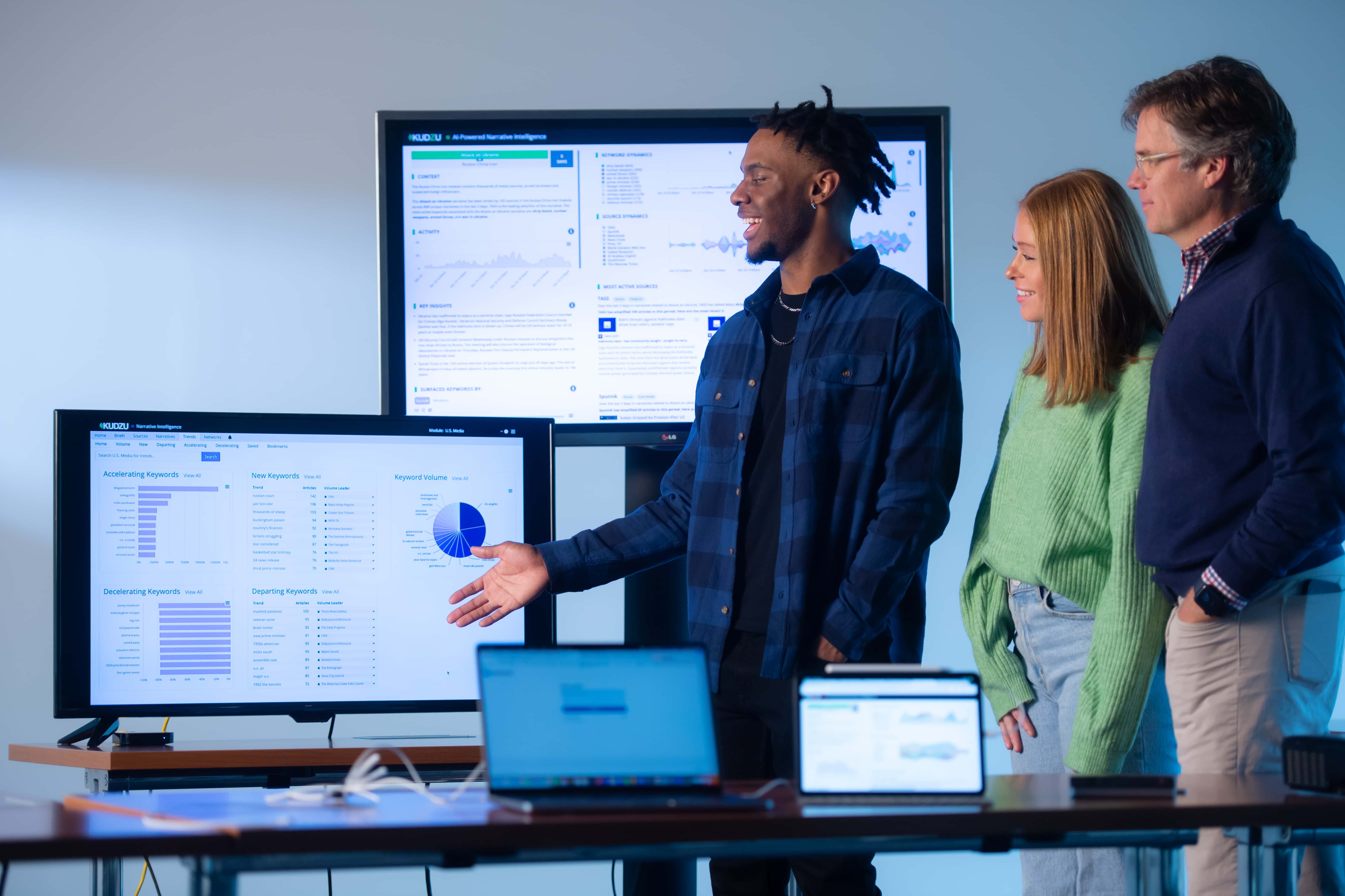 Students showing off graphics during a presentation. 