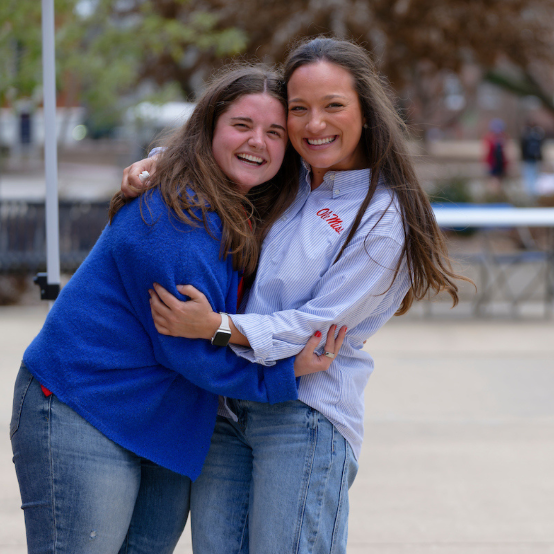 Two students hugging on campus.