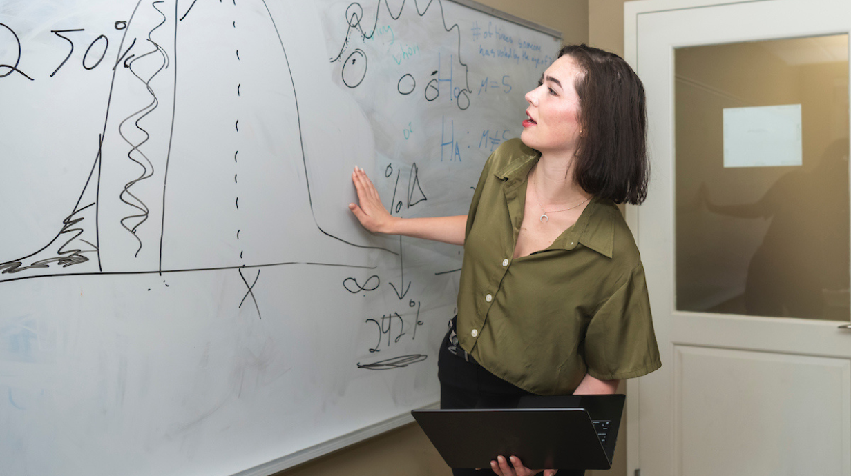 Doctoral student learning in classroom.