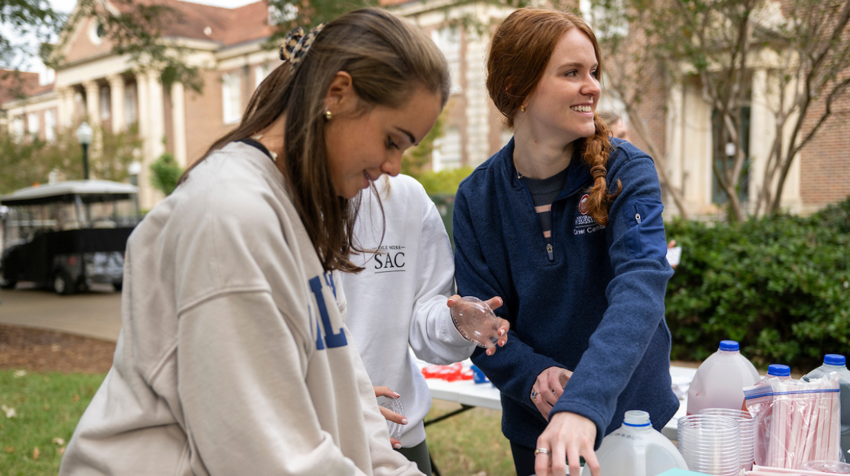 Students handing out drinks and snacks.