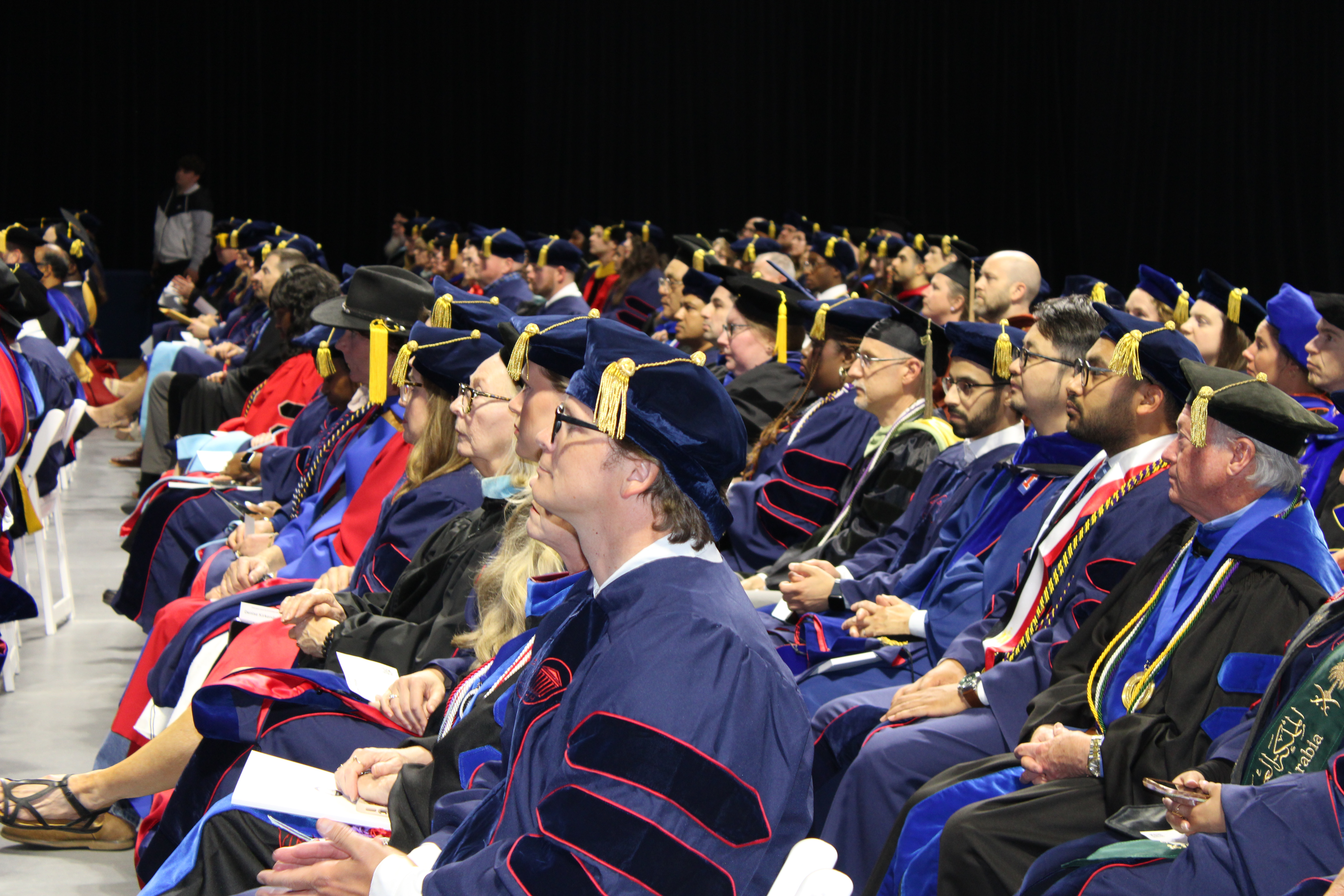 graduates and faculty at the ceremony