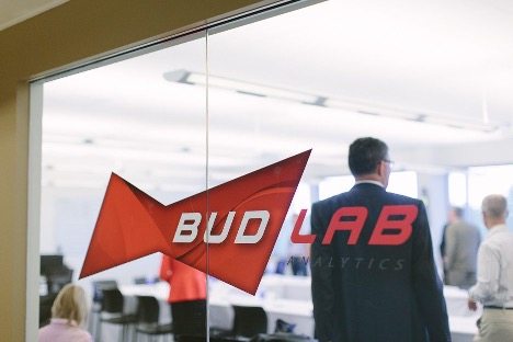 Man in suit walking into BUD Lab